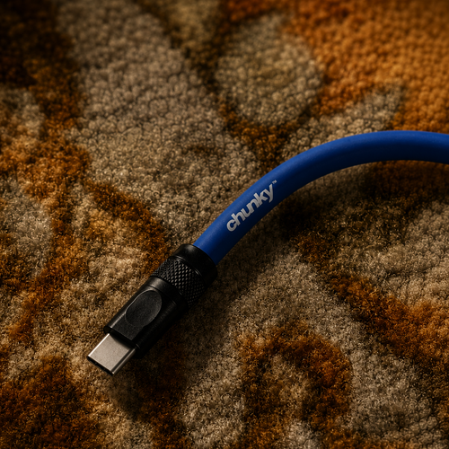 Blue USB cable with 'chunky' branding on a textured brown surface